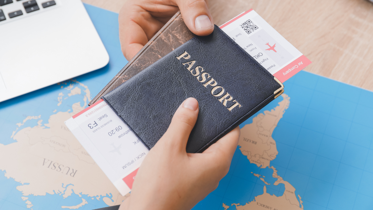 A person holding a passport and tickets

Description automatically generated